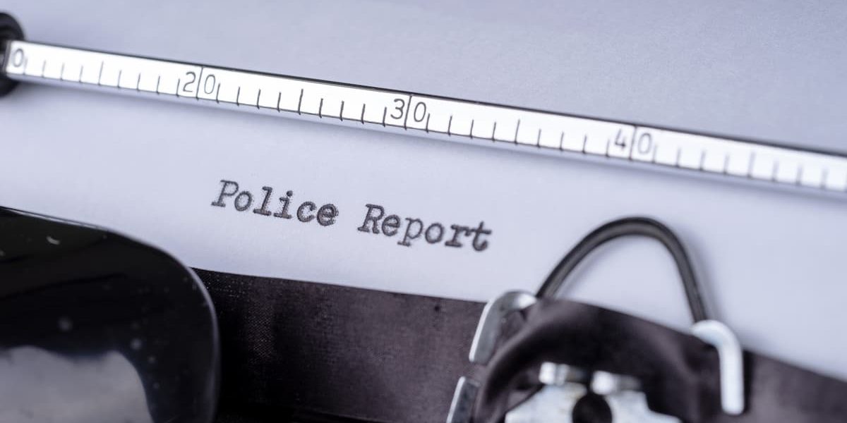 Close-up of police report document highlighting insurance dispute over incorrect accident findings in California claim